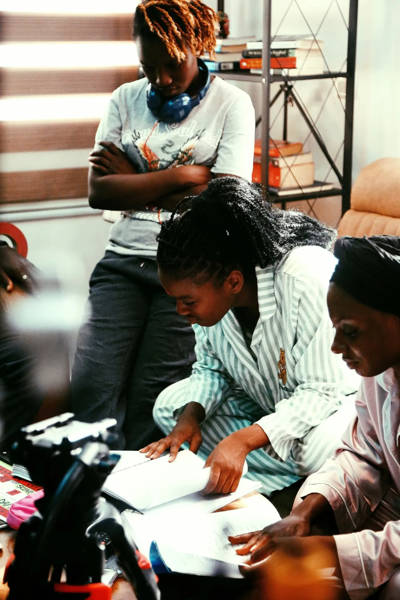 Black women reviewing materials together during a collaborative work session.